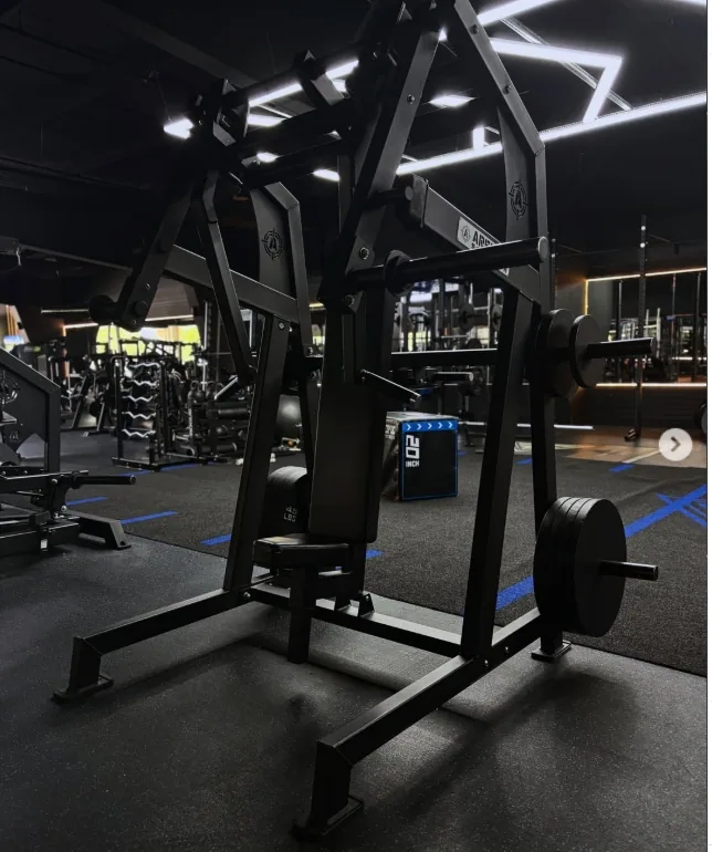 Plate loaded strength machine on the gym floor