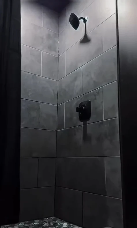 Dark tiled luxury shower at Fuel Fortress